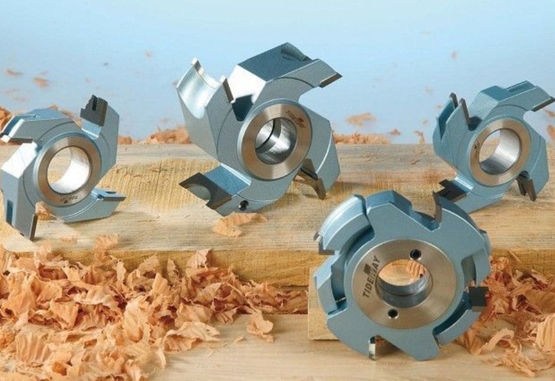 Indexable cutter heads with replaceable carbide knives for wood routing