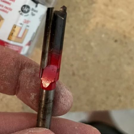Router bit chipping and burn marks on a damaged cutting edge
